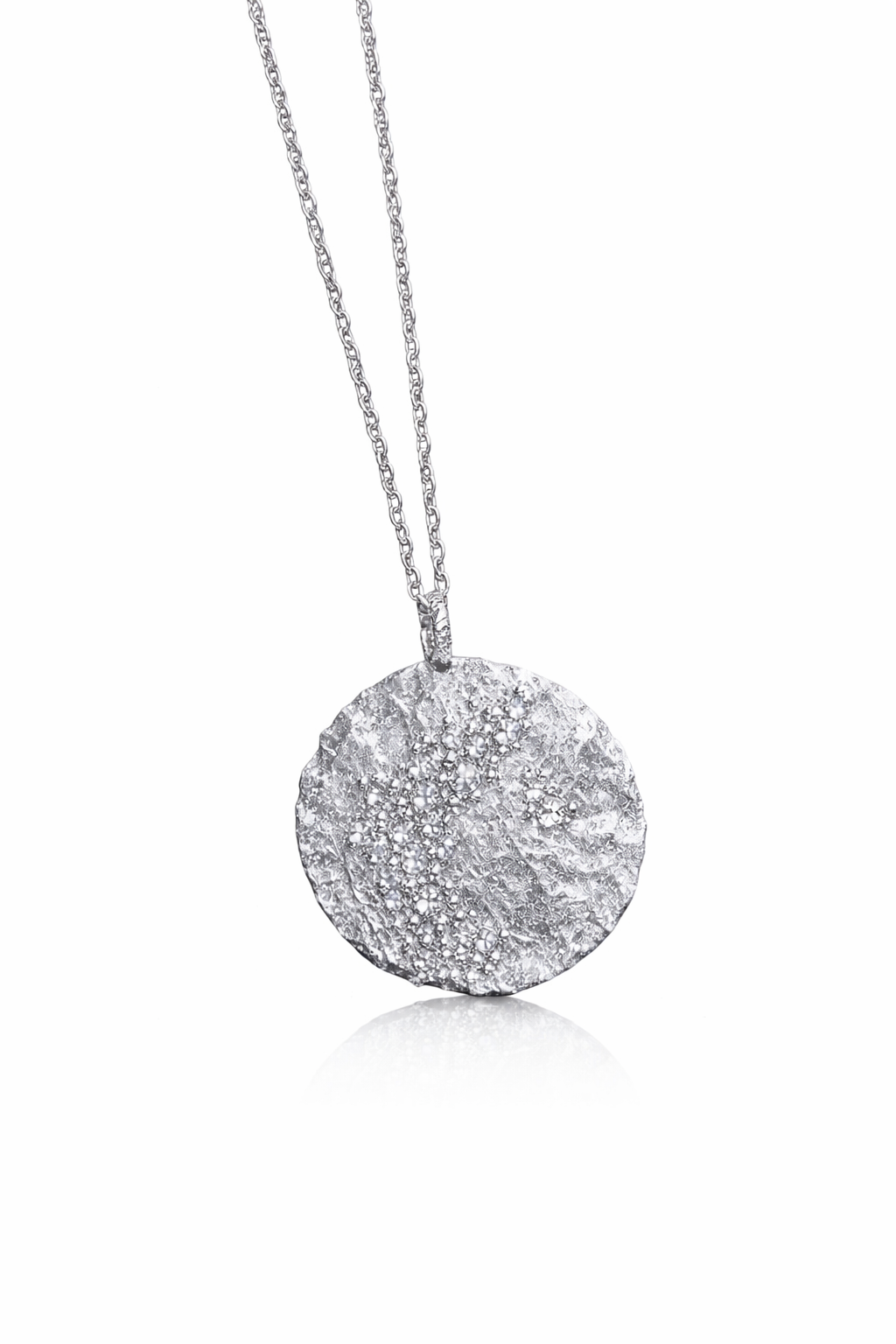 Near Earth Object | Silver necklace with a textured pendant on a white background