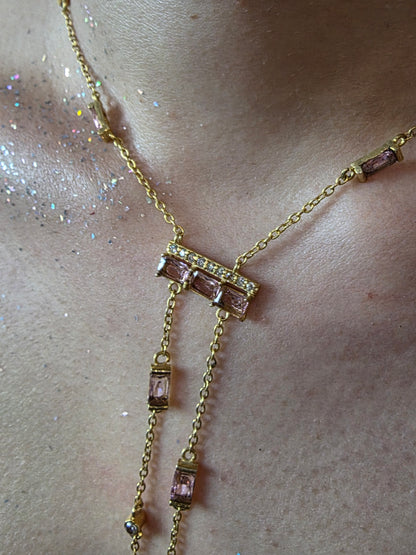 Near Earth Object | Gold anklet with pink gemstones on a light skin background