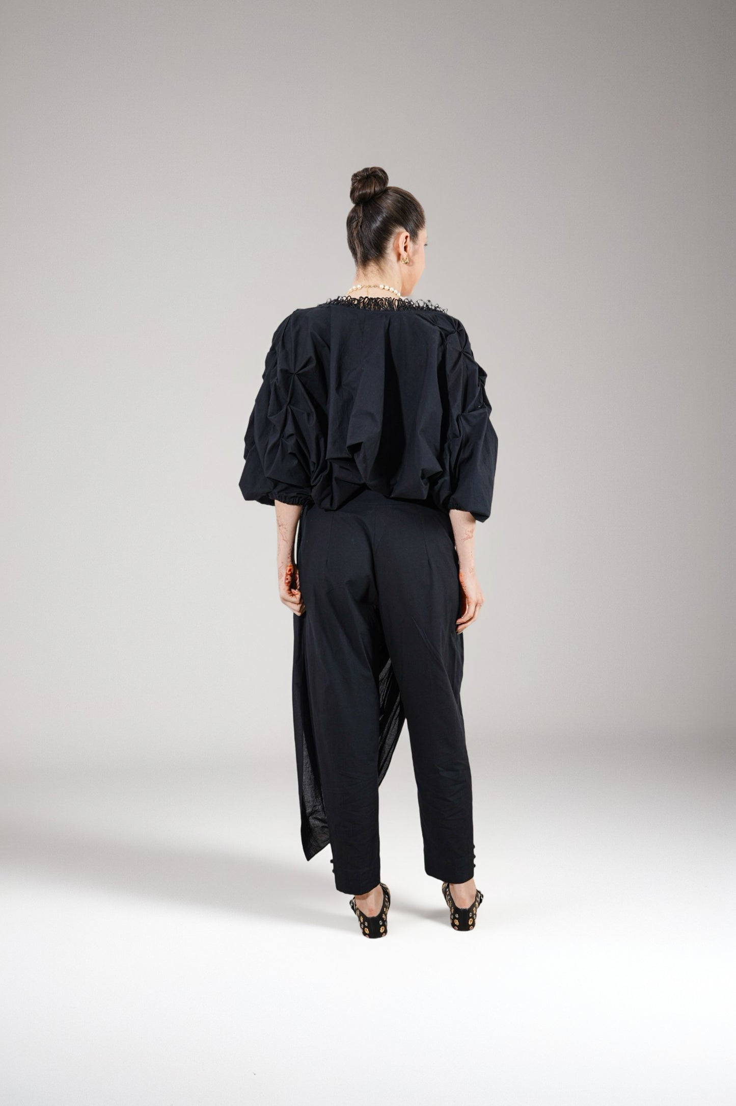 Person wearing a black outfit with puffed sleeves | Women's Shrug | Jacket | Pret Clothes | nEo Clothes.