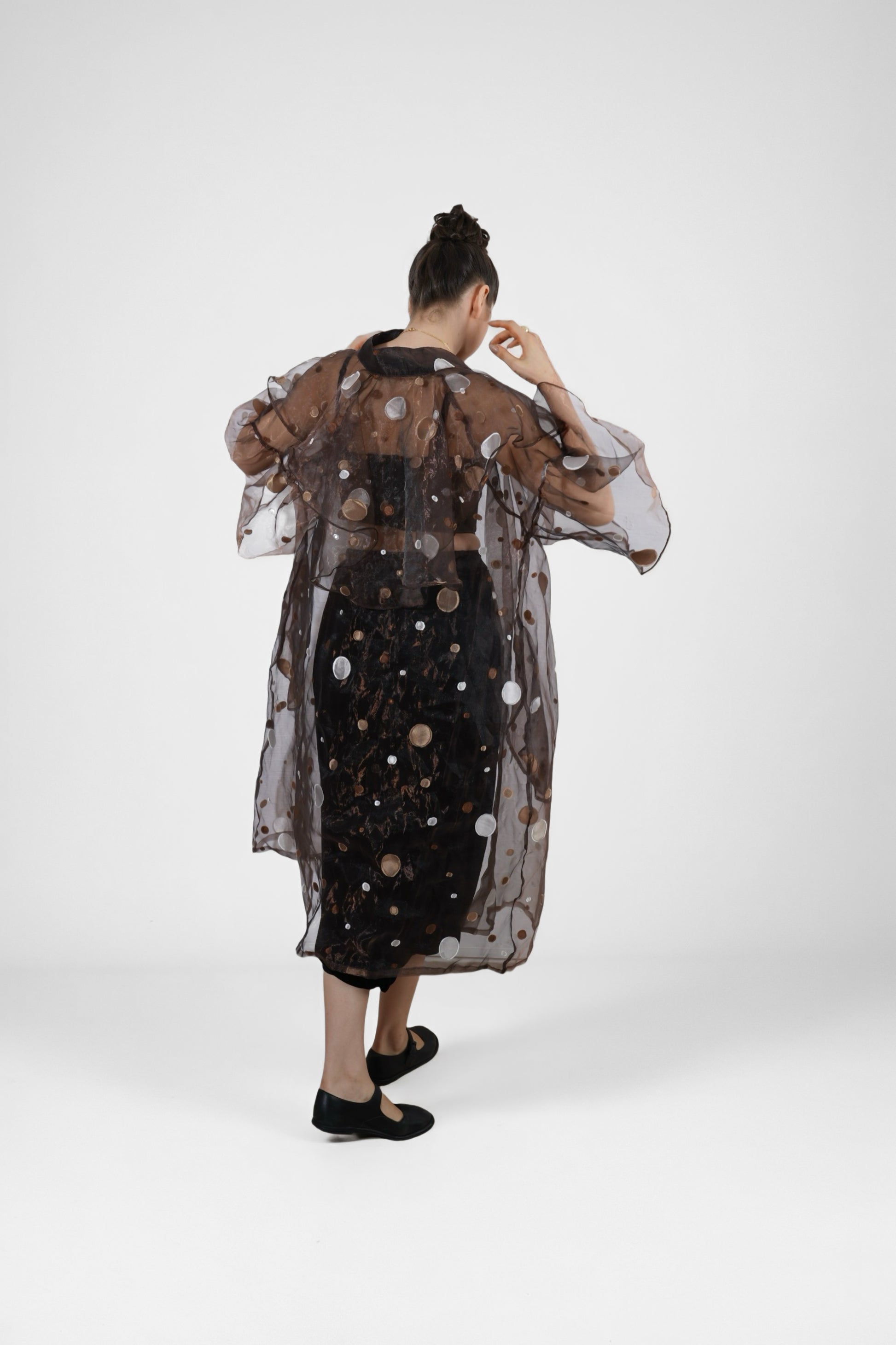 Person wearing a sheer black overlay polka dot dress  | Women's Overlay | Jacket & camisole | Pret Clothes | nEo Clothes.
