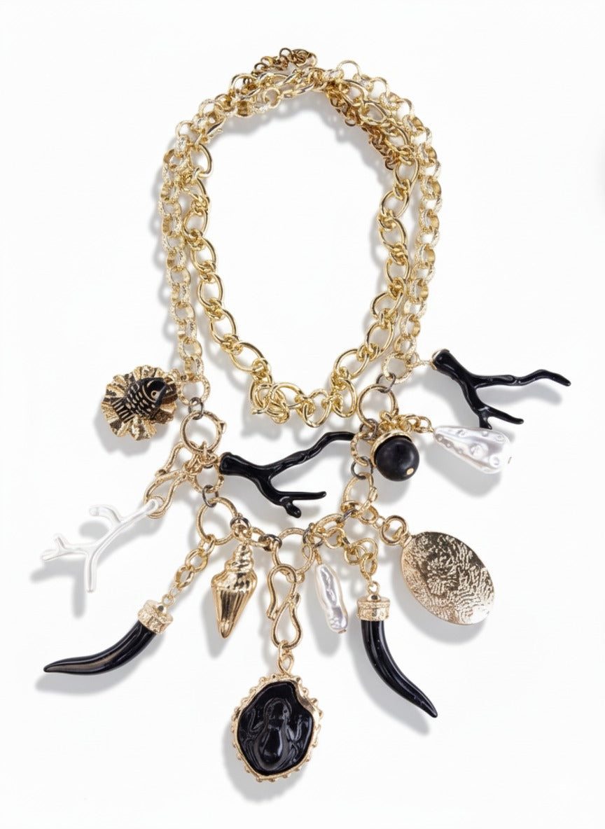 Gold statement charm necklace with celestial black-and-white pendants – sculptural fashion jewellery by Near Earth Object