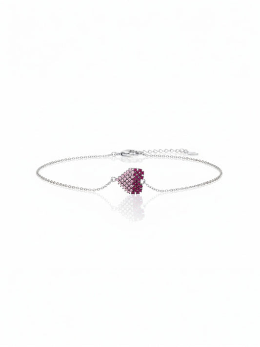 Silver bracelet featuring a cushion-cut ruby centerpiece surrounded by micro pavé stones.