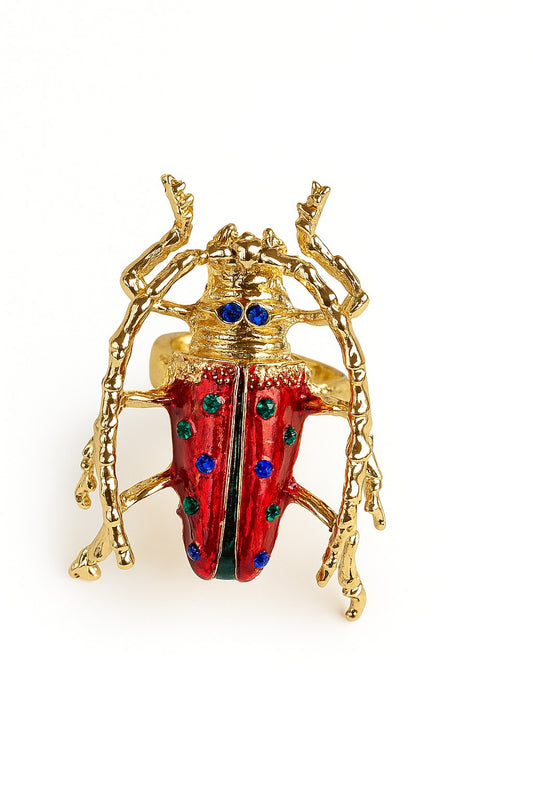 Gold and red sculptural beetle brooch with blue gemstone detailing – statement celestial accessory by Near Earth Object