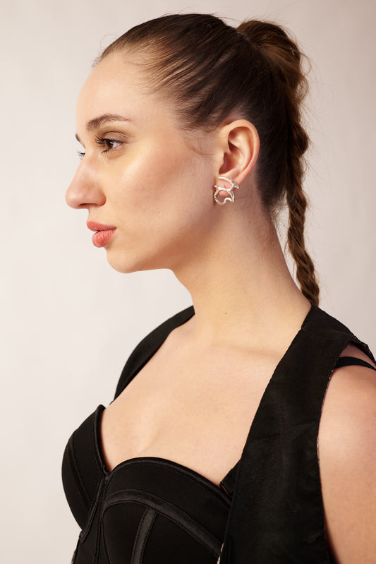 Model wearing silver abstract-line earrings – elegant modern jewellery by Near Earth Object.