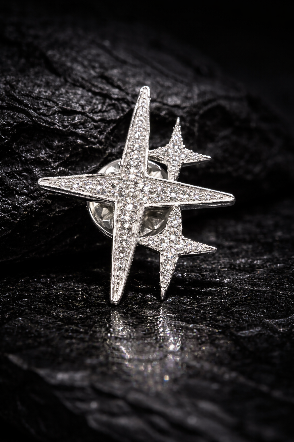 Near Earth Object | Star-shaped silver ring with embedded stones on a dark textured surface