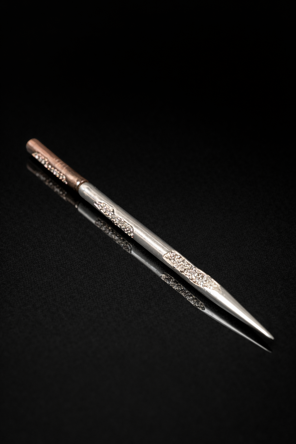 Near Earth Object | Decorative metal tool on a black background