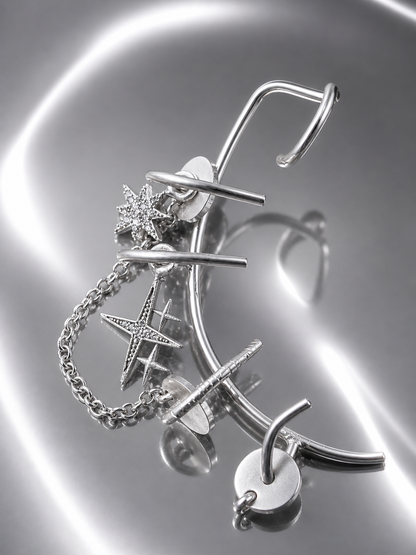Near Earth Object | Silver jewelry set with star-shaped earrings and necklace on a reflective surface