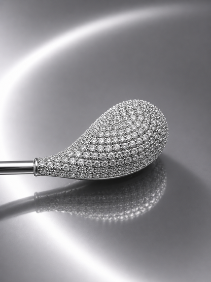 Near Earth Object | Diamond-studded teardrop-shaped object on a reflective surface