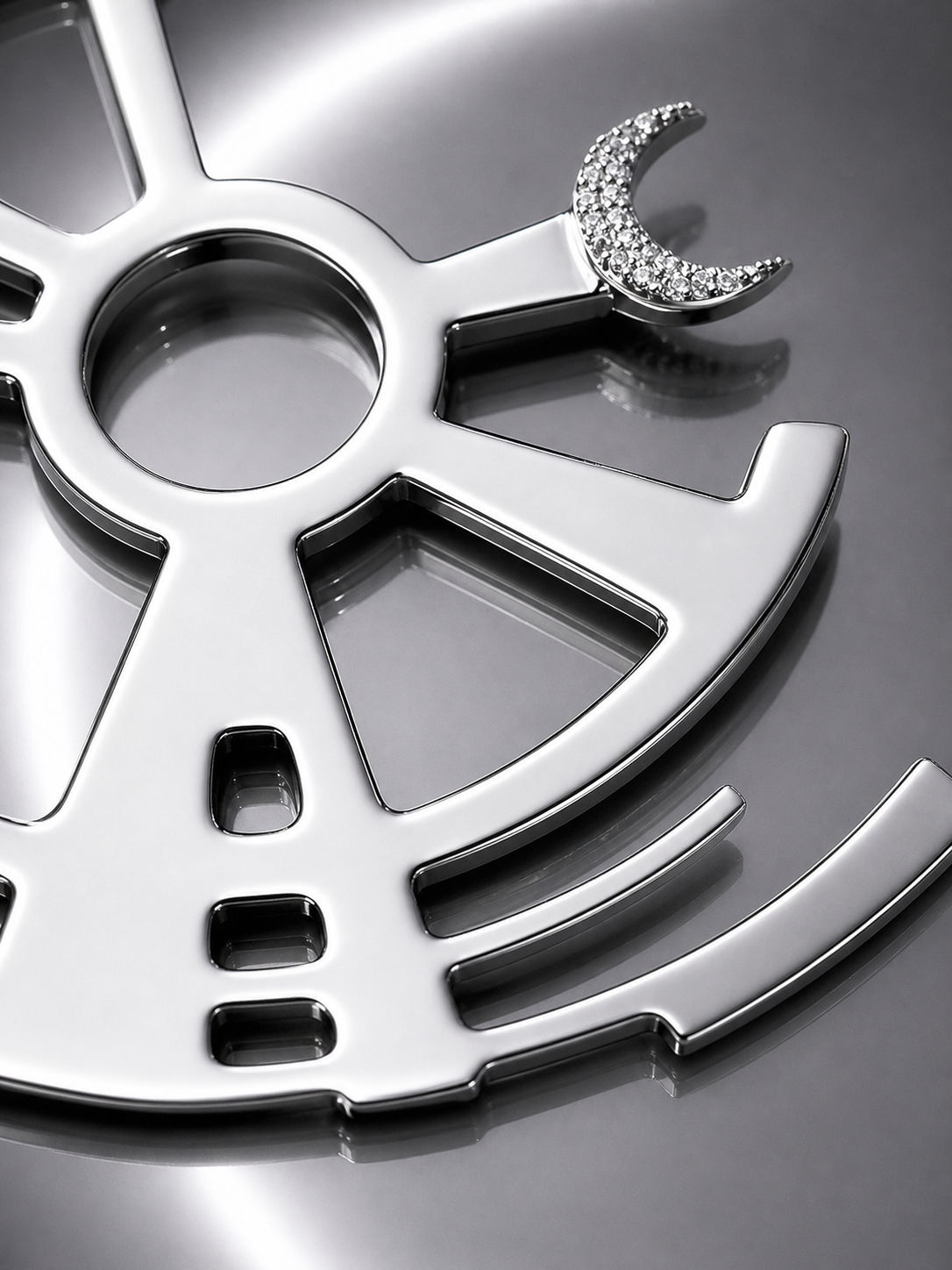 Near Earth Object | Close-up of a metallic gear with a wrench on a reflective surface