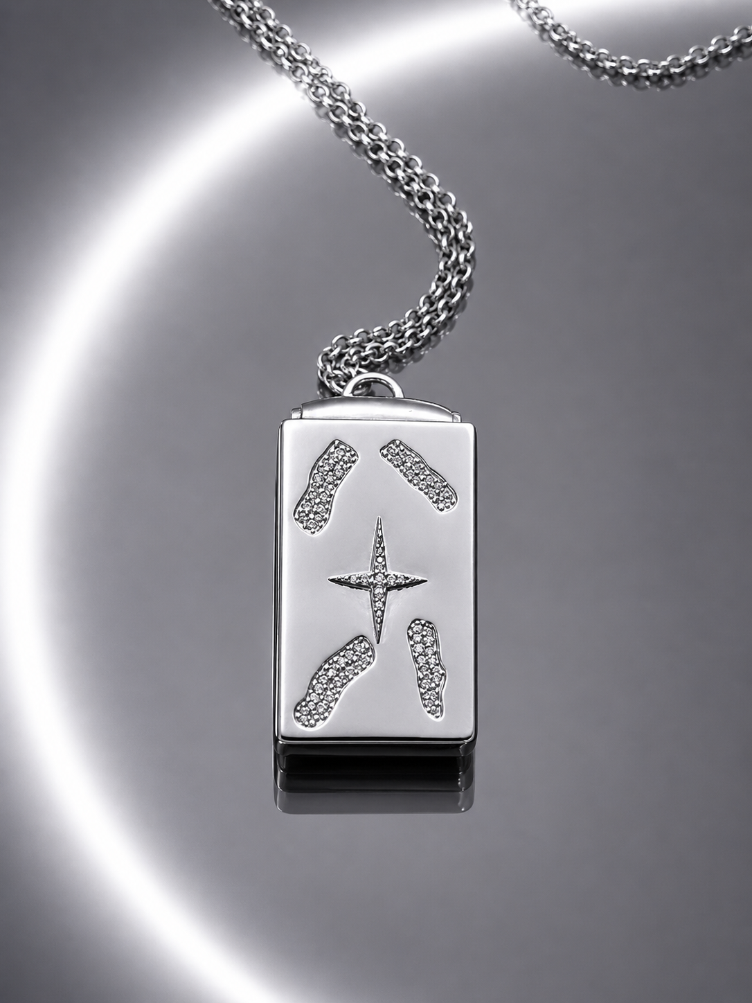 Near Earth Object | Silver pendant with star design on a reflective surface