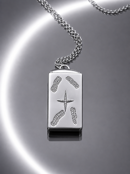 Near Earth Object | Silver pendant with star design on a reflective surface