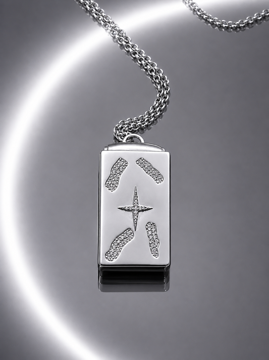 Near Earth Object | Silver pendant with star design on a reflective surface