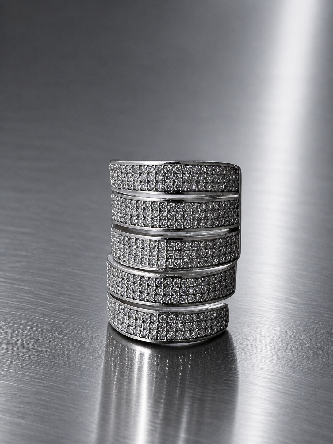 Stack of diamond-studded rings on a metallic surface