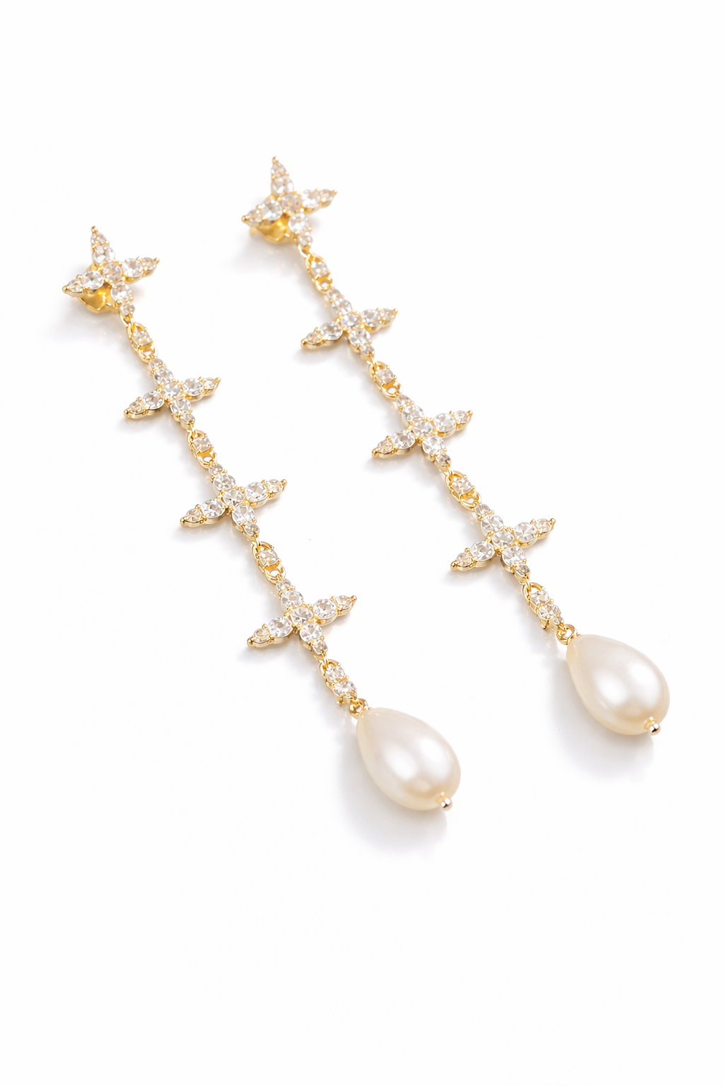 Near Earth Object | Pair of gold earrings with star and teardrop designs on a white background