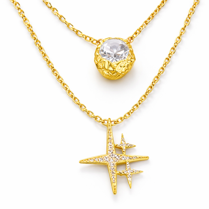 Near Earth Object | Gold necklace with a star-shaped pendant and clear gemstone on a white background