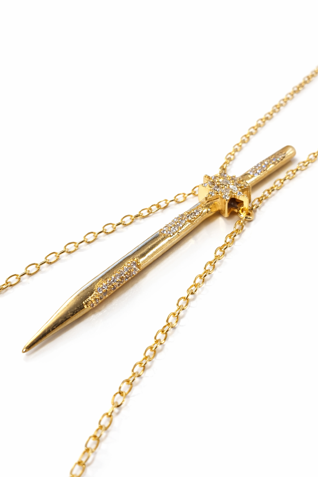 Near Earth Object | Gold dagger-shaped pendant with chain on a white background