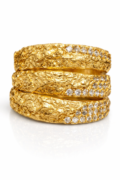 Near Earth Object | gold rings with diamond accents on a white background