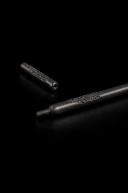 Near Earth Object | Two metallic objects with textured surfaces on a black background