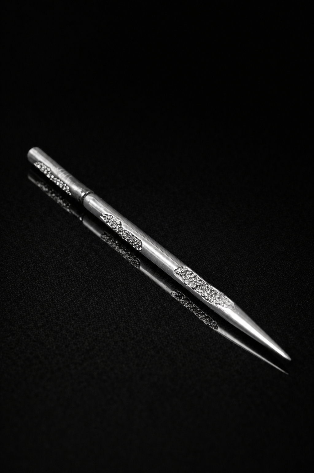 Near Earth Object | Silver tweezers on a black background