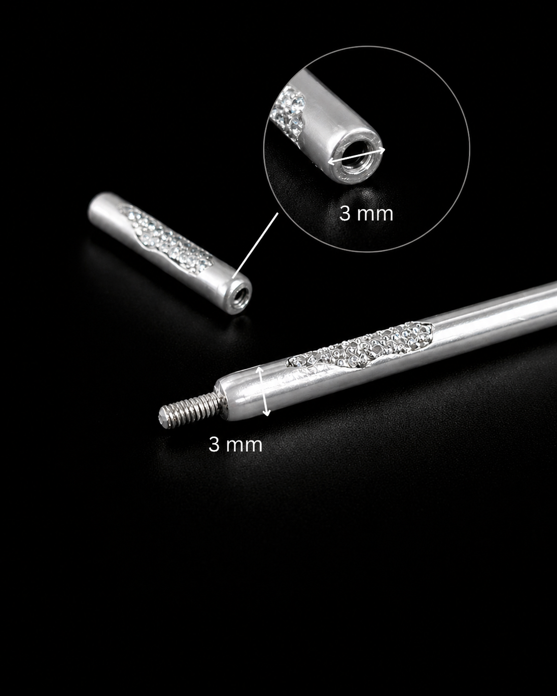 Near Earth Object | Silver cylindrical object with decorative elements on a black background