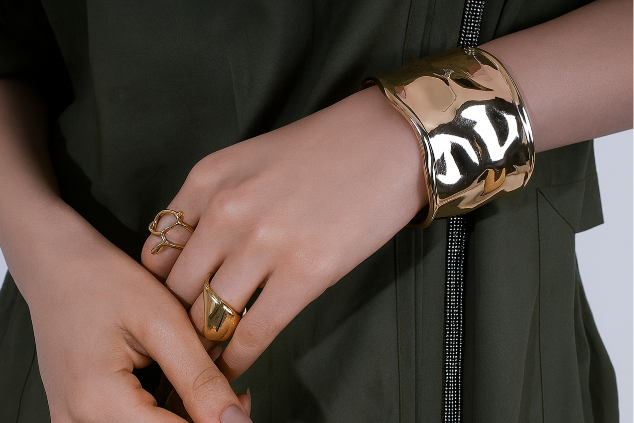 Gold bracelet and ring on a person's wrist| Statement Handcuff | Bracelet | neo jewelry 