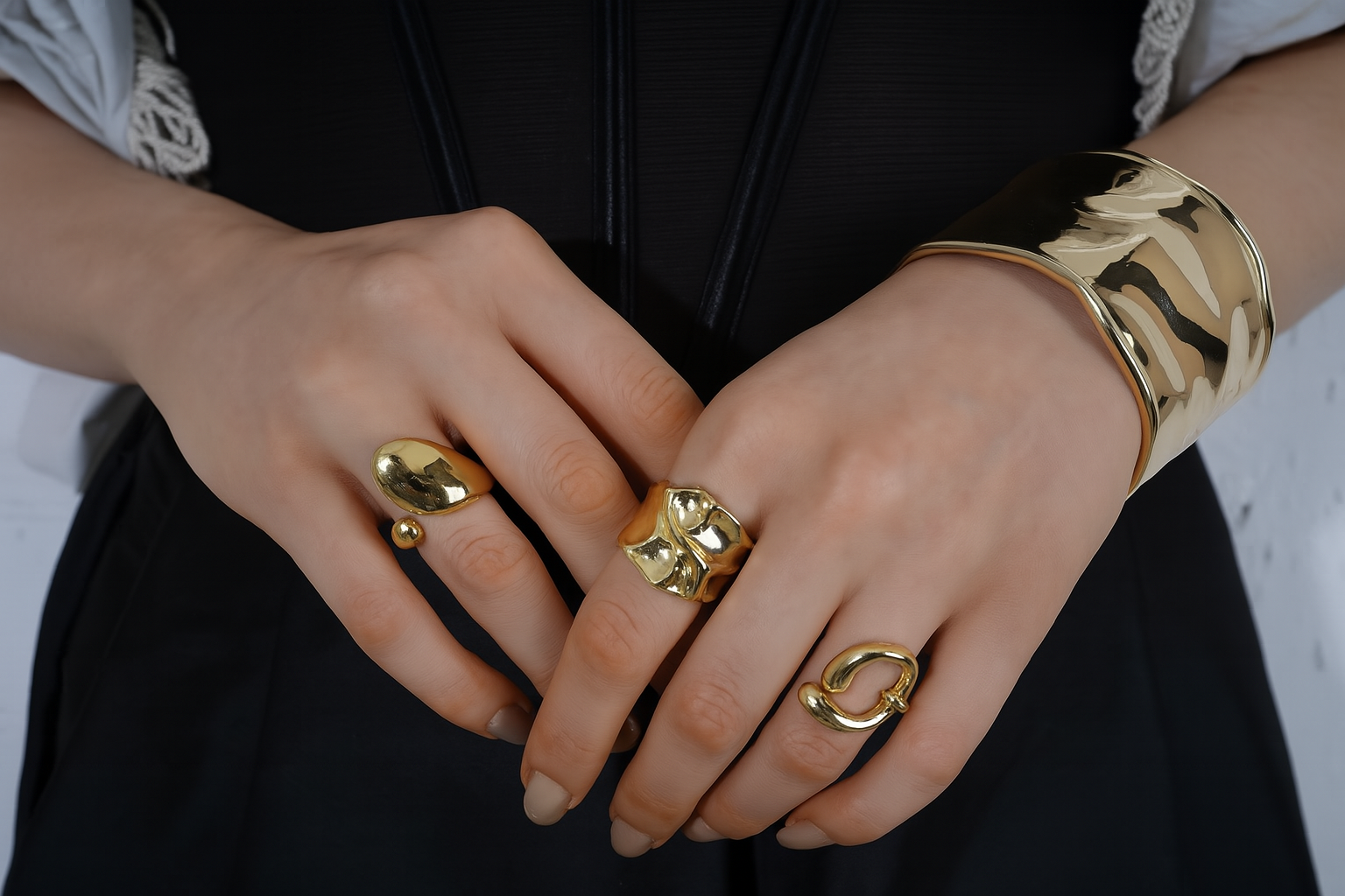 Close-up of hands wearing gold rings and a bracelet | Statement Ring | Asymmetrical Ring | neo jewelry 