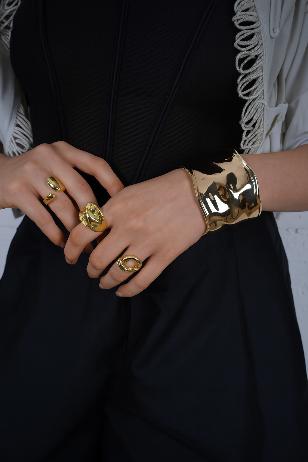 Close-up of hands wearing gold rings and a bracelet| Statement Ring | Asymmetrical Ring | neo jewelry 