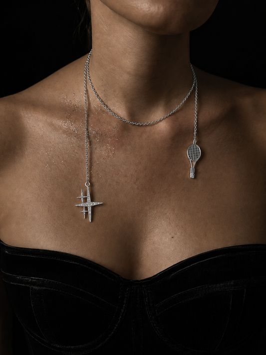 Near Earth Object | Silver necklace with two pendants on a dark background