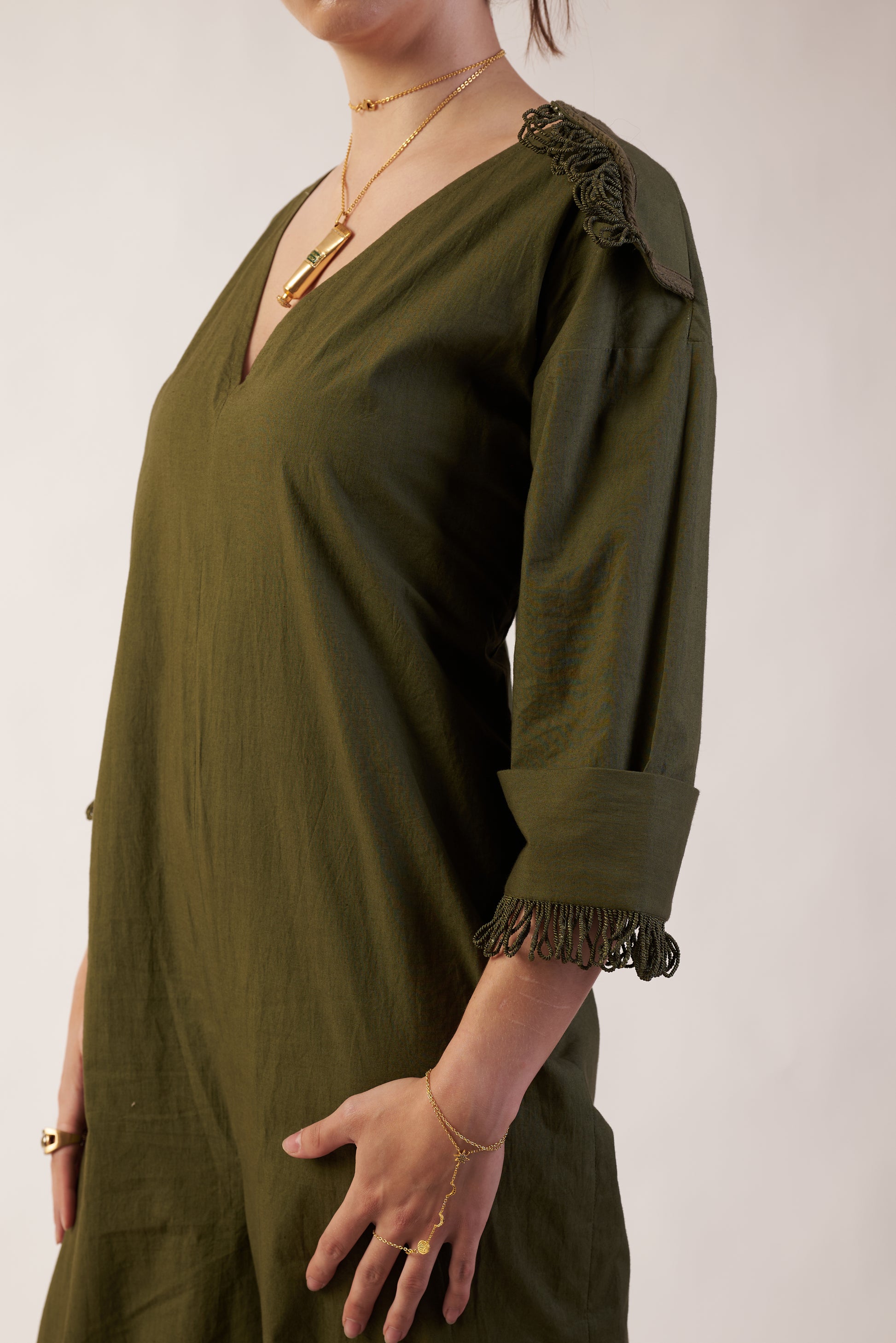 Cosmic Eclipse Jumpsuit : Person wearing an olive green dress with long sleeves and ruffled shoulders - near Earth object | Women Jumpsuit | Pret Clothes | nEo Clothes.
