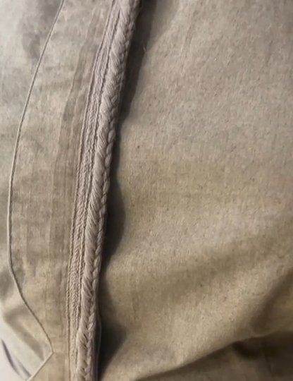 Crater Matter Set : Close-up of taupe fabric showcasing a finely stitched seam with delicate braided trim detailing, highlighting the craftsmanship and texture of the Top, taupe fabric close-up with braided seam detailing. | Women's Top | Pret Clothes - near Earth object | Asymmetrical Top | nEo Clothes.