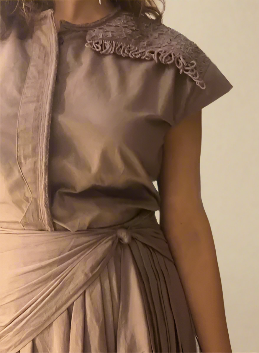 Crater Matter Set Close-up of a taupe draped Top featuring intricate shoulder embellishment with textured appliqué and knotted fringe and pleated waist drape tied in a knot, neutral toned designer Top  with textured shoulder embroidery - near Earth object | Women's Top | Pret Clothes | Asymmetrical Top| nEo Clothes