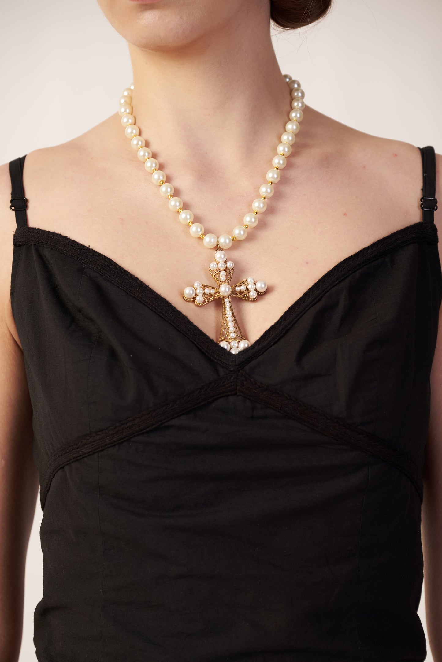 Eclipse Top : Pearl necklace with a cross pendant worn by a person in a black top - near Earth object | Women Co-ord Set | Pret Clothes | nEo Clothes.