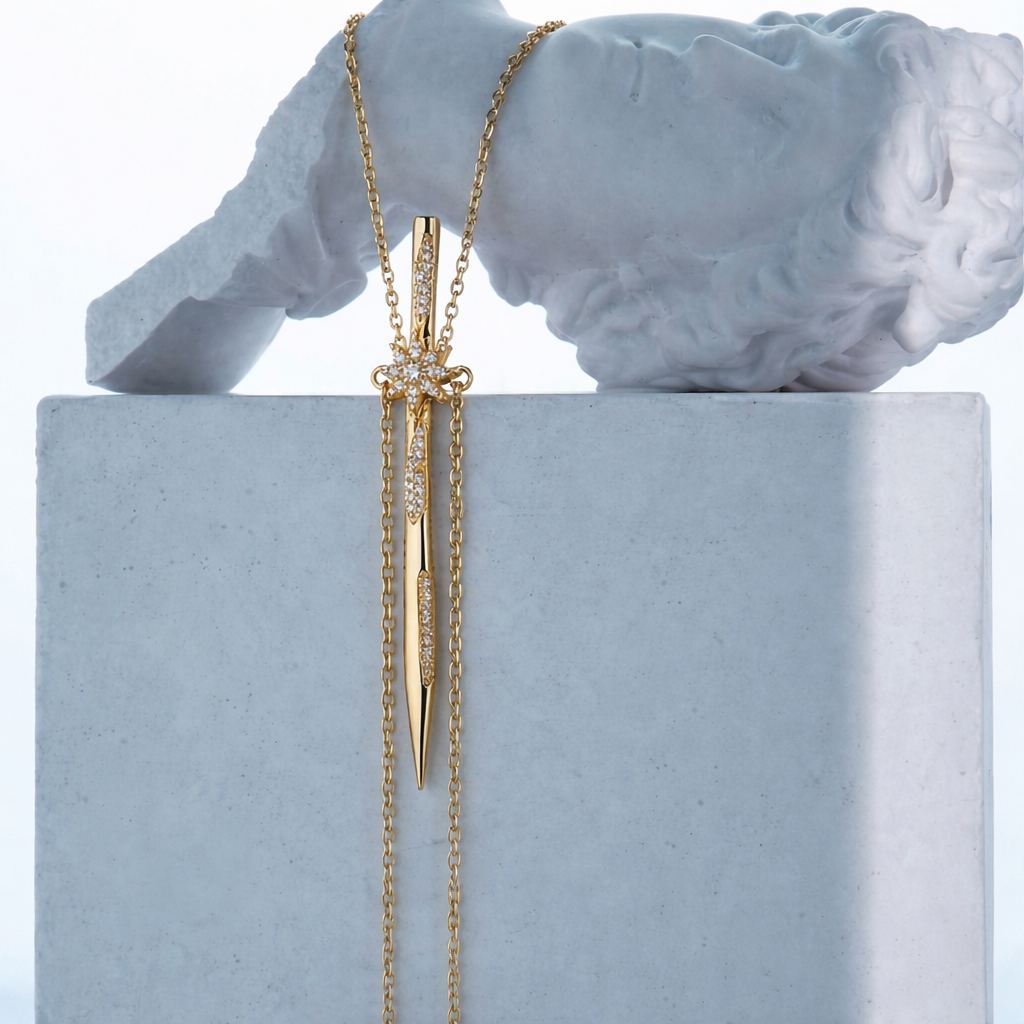 Near Earth Object | Gold necklace with a unique pendant on a gray pedestal with a classical sculpture in the background