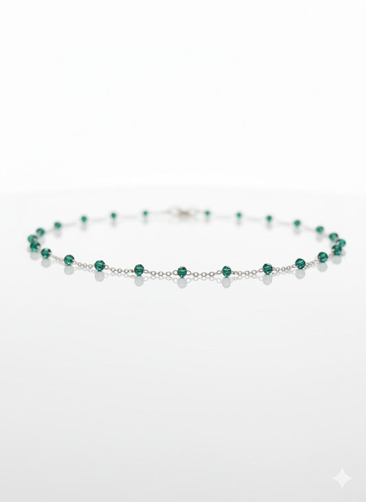 Delicate sterling silver bracelet with small emerald beads arranged in a minimal fine-jewellery line