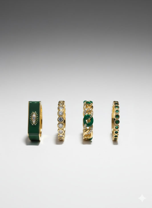 Gold and emerald ring set featuring mixed-cut stones and textured band designs by Near Earth Object