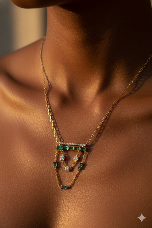 Model wearing gold layered green-stone necklace in warm editorial lighting – high-fashion luxury jewellery styling by Near Earth Object.