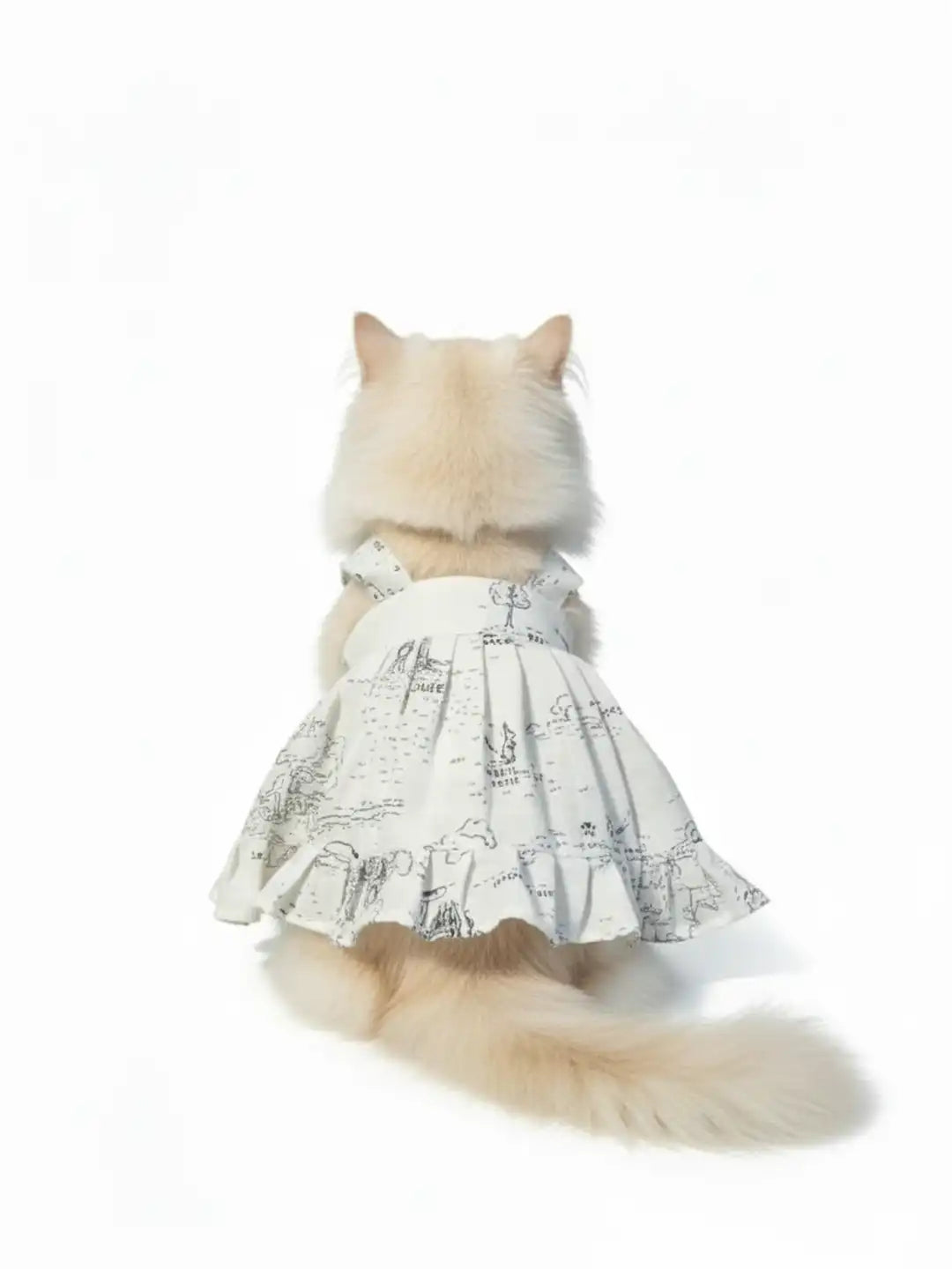 Dog wearing a white dress with black patterns