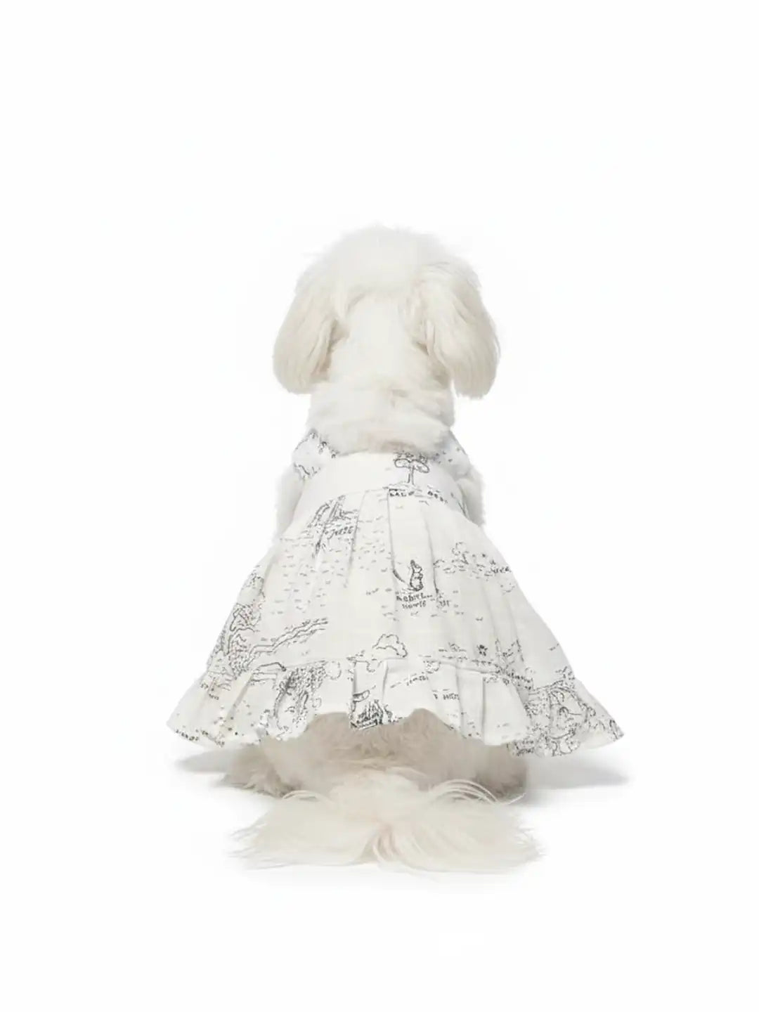 Dog wearing a white dress with black patterns 