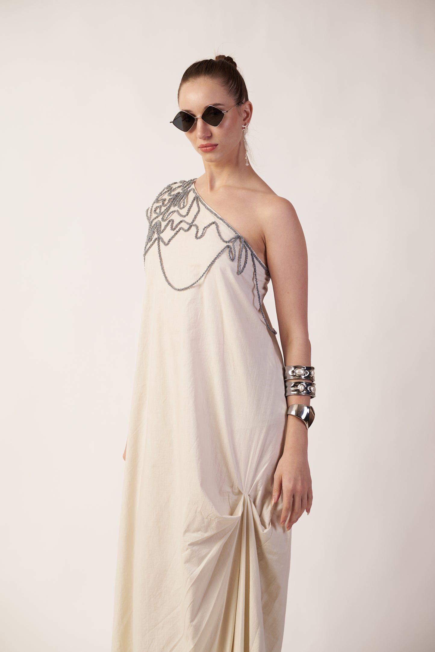 Ivory Wave : Woman wearing a one-shoulder dress with intricate detailing near Earth object | Women Dresses | Pret Clothes | nEo Clothes.