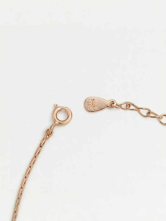 Close-up of rose-gold bracelet clasp and chain extension showcasing delicate pearl detailing – elegant modern accessory by Near Earth Object.
