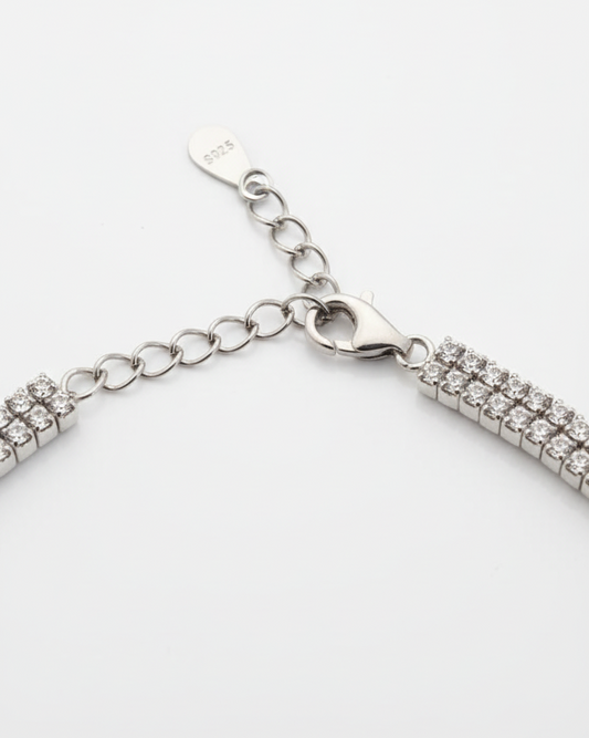 Close-up of bracelet clasp and chain extension showcasing silver and rose-gold link detailing – refined modern accessory by Near Earth Object.