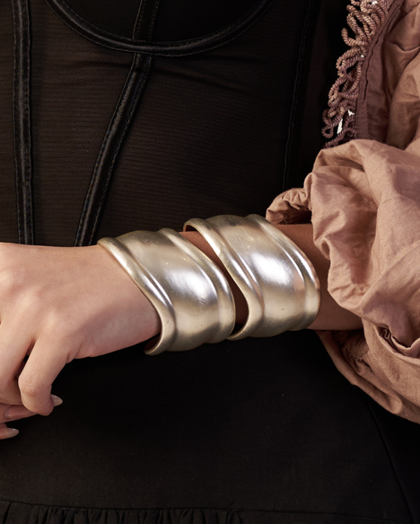 Model wearing silver sculptural wave cuff bracelet – elegant contemporary jewellery by Near Earth Object.