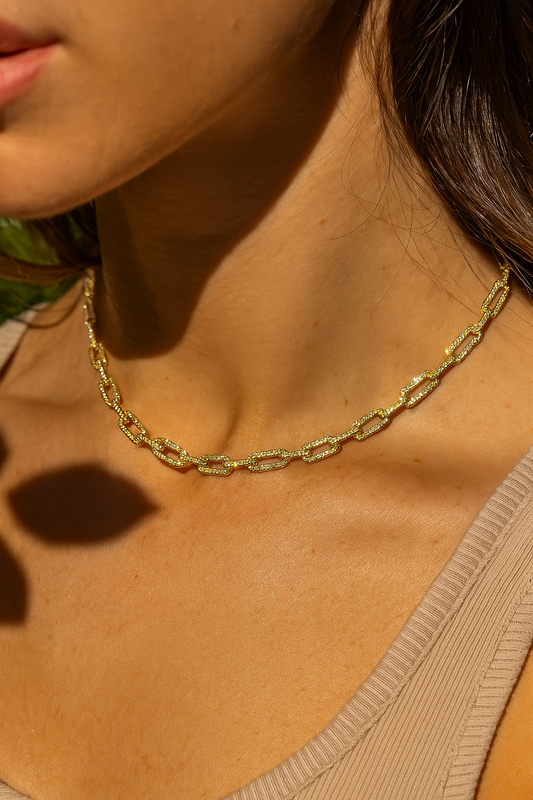 Model wearing gold paperclip chain choker in natural sunlight – sleek minimalist jewellery styling by Near Earth Object.