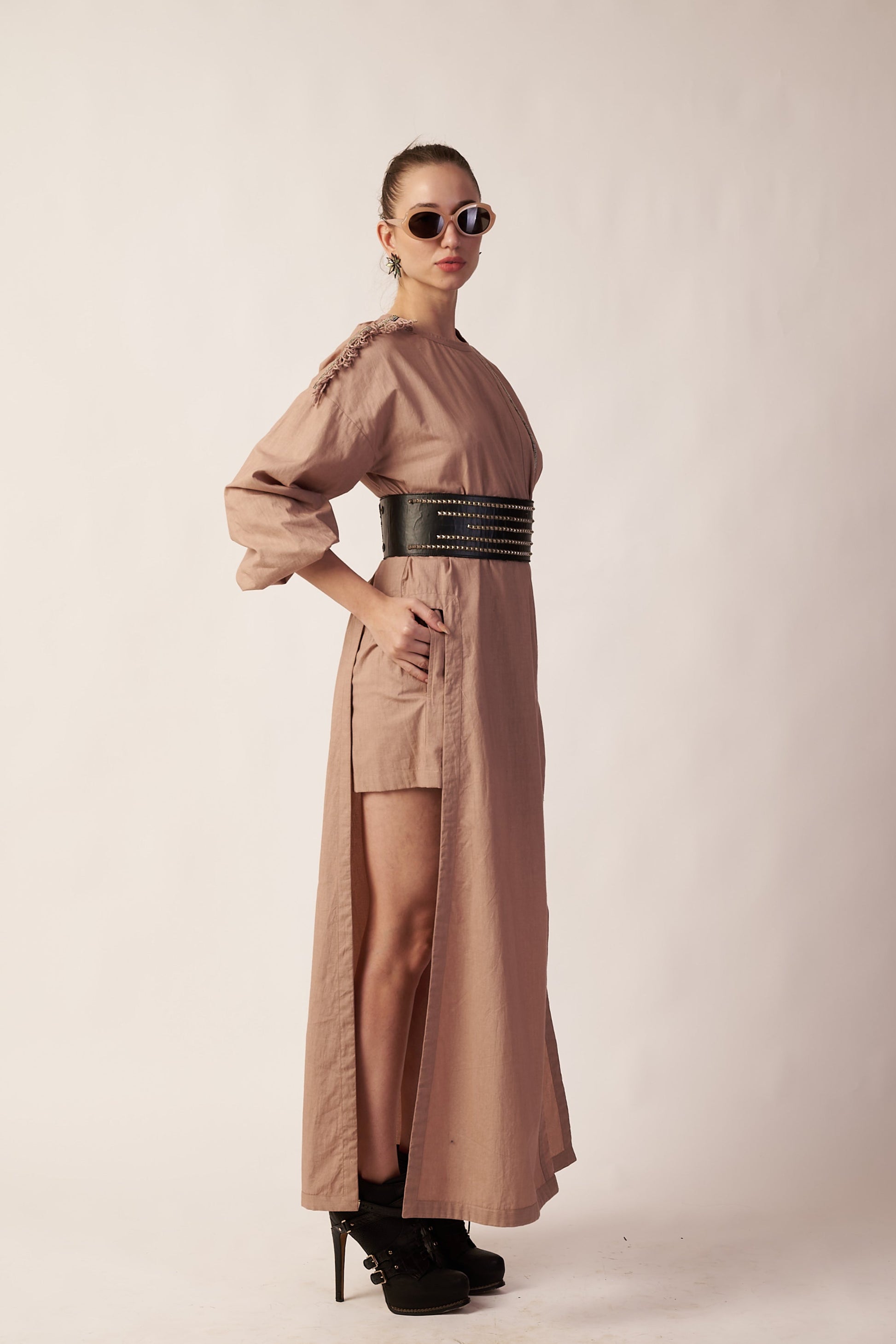 Lunar Trail Set :  Woman wearing a long beige dress with a belt - near Earth object 