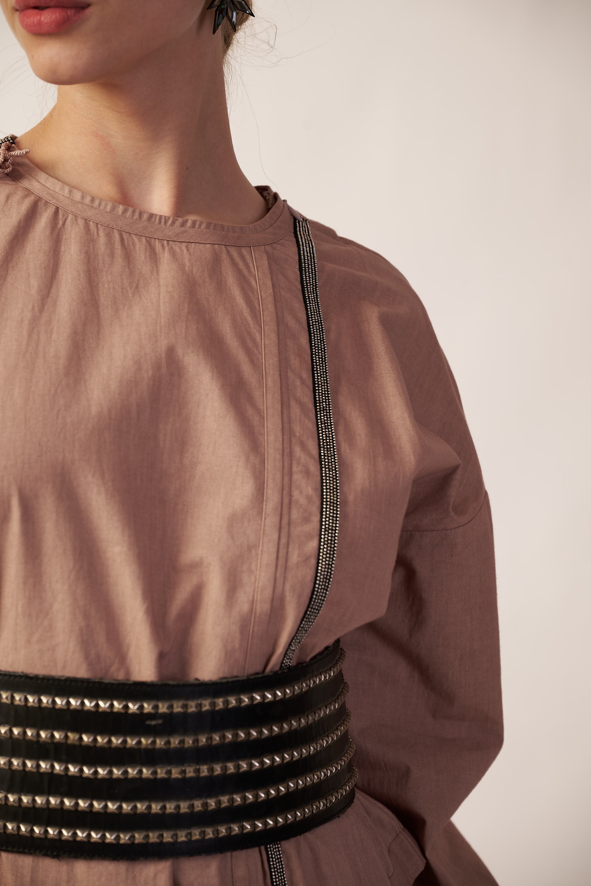 Close-up of a person wearing a brown top with decorative black trim - near Earth object | Women’s co-ord set | pret clothes | nEo clothes