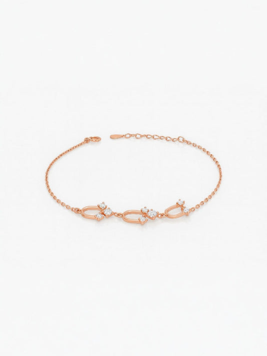 Gold bracelet featuring three intertwined infinity-style motifs with crystal accents — elegant symbolic jewellery by Near Earth Object.