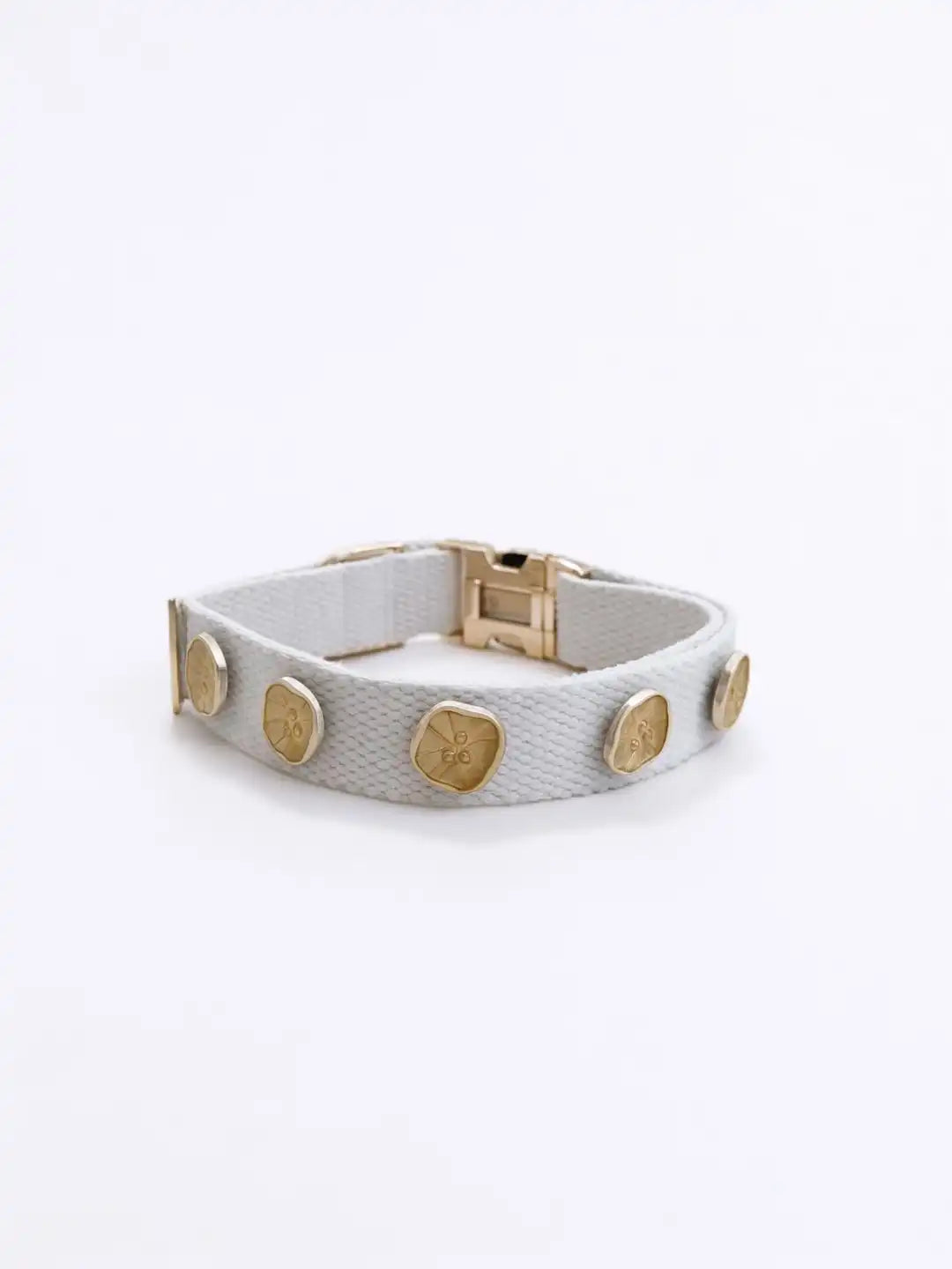 Gray leather bracelet with gold circular accents 