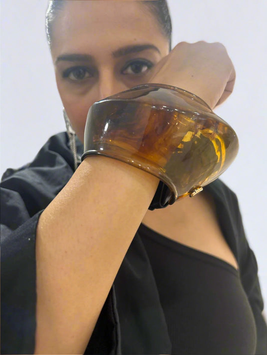Model wearing sculptural tortoiseshell cuff bracelet – bold modern accessory by Near Earth Object.