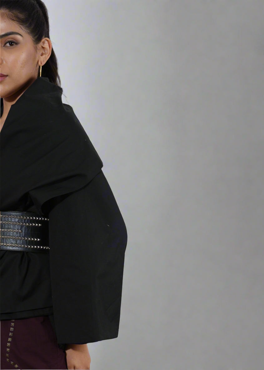 Woman wearing a black outfit with a decorative belt against | Women's Overlay & Camisole | Jacket | Pret Clothes | nEo Clothes.
