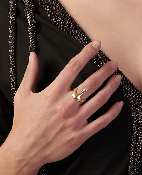 Gold ring on a hand with a black beaded garment | Statement Necklace & Chokers  | neo jewelry 